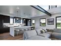 Bright, open kitchen with a large island, barstool seating, stainless steel appliances, and hardwood floors at 5358 Lions Paw St, Castle Rock, CO 80104