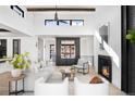 Bright living room with high ceilings, modern fireplace, and comfortable seating area at 5358 Lions Paw St, Castle Rock, CO 80104