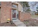The front entrance of this townhome has brick accents and stone steps at 11886 Elk Head Range Rd, Littleton, CO 80127