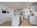 Bright kitchen with white cabinets, stainless appliances, and spacious island at 11886 Elk Head Range Rd, Littleton, CO 80127