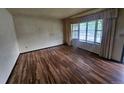 Living room featuring hardwood floors and a large window, providing natural light at 912 E 6Th Ave, Broomfield, CO 80020