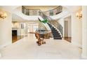 Grand entry with curved staircase and ornate detailing at 2 Cherry Hills Farm Dr, Cherry Hills Village, CO 80113