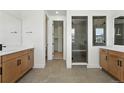 Modern bathroom with double vanity, tile floors, and glass-enclosed shower at 5629 Farrier Pt, Castle Rock, CO 80104
