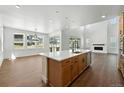 Bright, modern kitchen with stainless steel appliances, a large island, and hardwood floors at 5629 Farrier Pt, Castle Rock, CO 80104