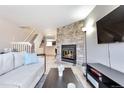 Stylish living area with a stone fireplace, modern furniture, and a cozy atmosphere at 1011 Milo Cir # A, Lafayette, CO 80026