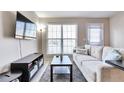 Comfortable living room with a large window, TV, sofa, and a serene ambiance at 1011 Milo Cir # A, Lafayette, CO 80026