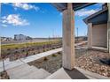 Landscaped front yard with walkway leading to townhome entrance at 16748 W 93Rd Pl, Arvada, CO 80007