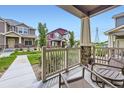 Comfortable front porch showcasing neighborhood views and stylish design elements at 17855 E 103Rd Ave, Commerce City, CO 80022