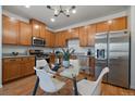 Modern kitchen with wood cabinets, granite countertops and stainless steel appliances at 1841 S Dunkirk St # 203, Aurora, CO 80017