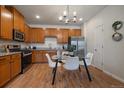 Well-equipped kitchen with stainless steel appliances, granite countertops, and a bright dining area with modern lighting at 1841 S Dunkirk St # 203, Aurora, CO 80017