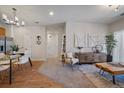 Open-concept living area with stylish decor and a view of the kitchen and dining area at 1841 S Dunkirk St # 203, Aurora, CO 80017