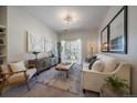 Cozy living room with stylish decor, neutral colors, and sliding doors to a balcony at 1841 S Dunkirk St # 203, Aurora, CO 80017