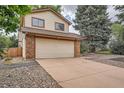 Two-story house with a spacious driveway and a low maintenance rock garden at 18984 E Kent Cir, Aurora, CO 80013
