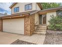 Inviting two-story home, showing the house number, brick accents and steps leading up to the front door at 18984 E Kent Cir, Aurora, CO 80013