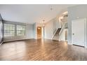 Bright living room with wood floors, large windows and a staircase leading to the upper level at 18984 E Kent Cir, Aurora, CO 80013