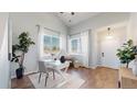 Bright office space with hardwood floors, natural light, and a modern white desk and décor at 6898 W Rockland Pl, Littleton, CO 80128