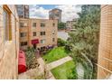 The complex is a multi-story brick building with well-maintained green spaces at 1100 Colorado Blvd # 305, Denver, CO 80206
