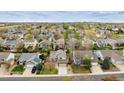 A birds eye view of suburban homes with green trees and yards on a sunny day at 5174 S Ukraine St, Aurora, CO 80015