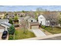 An elevated view of a two-story home with a green lawn in a suburban neighborhood at 5174 S Ukraine St, Aurora, CO 80015