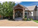 Stone and stucco home with a large covered porch at 4479 Tierra Alta Dr, Castle Rock, CO 80104
