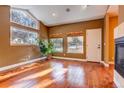 Bright living room featuring hardwood floors, fireplace, and lots of natural light at 5255 Ridge Trl, Littleton, CO 80123