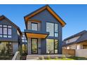 Stylish two-story home with a combination of brick and dark wood siding at 410 S Vine St, Denver, CO 80209