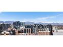 Stunning panoramic city view, framed by modern buildings and distant snow-capped mountains at 2020 Arapahoe St # 1130, Denver, CO 80205