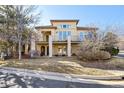Elegant two-story home with a balcony, showcasing architectural details and a well-maintained front lawn at 13901 E Saratoga Pl, Aurora, CO 80015