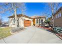 Charming single-story home showcasing a well-manicured yard, attached garage, and inviting yellow front door at 13901 E Saratoga Pl, Aurora, CO 80015