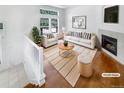 Bright living room showcasing a fireplace and large windows for natural light at 1491 Ophir Rd, Castle Rock, CO 80109