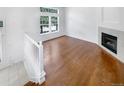 Bright and airy living room with hardwood floors and a cozy fireplace at 1491 Ophir Rd, Castle Rock, CO 80109