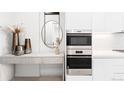 Decorative display shelf featuring decor next to stainless steel ovens at 1901 Wazee St # 304, Denver, CO 80202