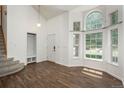 Bright living room with vaulted ceilings, hardwood floors, and large windows allowing ample natural light at 20445 Mitchell Pl, Denver, CO 80249