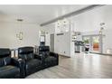 Open-concept living area with modern lighting fixtures, seamlessly connecting the living and kitchen spaces at 3902 S Uravan St, Aurora, CO 80013