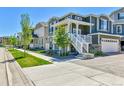 Street view of an attractive suburban home with a white porch and green lawn at 1086 Highlands Dr, Erie, CO 80516