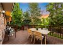 Relaxing outdoor deck with a dining table, chairs, and beautiful green scenery; perfect for enjoying the outdoors at 7308 S Steele Cir, Centennial, CO 80122