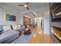 Open-concept living room with hardwood floors, fireplace, and seamless flow to the dining area at 1655 N Williams St, Denver, CO 80218