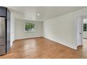 Spacious living room featuring neutral paint, wood floors, and natural light at 495 Quebec St, Denver, CO 80220