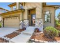 Inviting two-story home with landscaped entrance, stone accents, and a convenient two-car garage at 11089 Woodhurst Cir, Highlands Ranch, CO 80130
