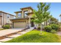 Inviting two-story home with landscaped lawn, stone accents, and a convenient two-car garage at 11089 Woodhurst Cir, Highlands Ranch, CO 80130