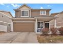 Charming two-story home featuring a covered porch, attached garage, and well-maintained landscaping at 20826 Robins Dr, Denver, CO 80249