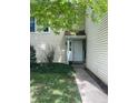 Inviting front entrance with well-maintained lawn and fresh landscape at 482 S Kalispell Way # E, Aurora, CO 80017