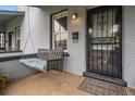 Inviting front porch with a swing, decorative door, and charming details at 3764 N Raleigh St, Denver, CO 80212