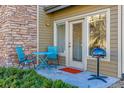 Outdoor patio with table, chairs, grill, and access to the front entrance at 18287 E Floyd Ave # L, Aurora, CO 80013