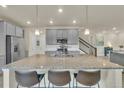 Spacious kitchen island with granite countertops, pendant lighting and breakfast bar at 4884 St Vrain Rd, Firestone, CO 80504