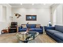 Bright living area with stylish seating, a glass table, and unique decor, perfect for relaxing or entertaining guests at 168 S Garfield St, Denver, CO 80209