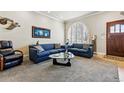 Inviting living room with neutral carpet, large arched window, and comfortable seating creating a cozy atmosphere at 168 S Garfield St, Denver, CO 80209