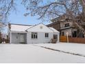 Charming bungalow home with snow-covered front yard at 2615 N Steele St, Denver, CO 80205