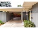 The carport is attached to the house and contains a storage area, along with access to the front door at 1338 S Fairfax St, Denver, CO 80222