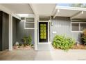 Unique front door of a stylish home, complemented by modern exterior design and well-kept landscaping at 1338 S Fairfax St, Denver, CO 80222